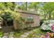 Backyard shed with window boxes and stone pathway, surrounded by lush landscaping and flowering plants at 4 Arc Ne Way, Atlanta, GA 30305