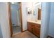 Bathroom with vanity, sink, mirror, wood cabinets and tile floors at 4020 Cranwood Dr, Atlanta, GA 30349