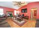 Spacious living room with a stone fireplace, wood floors, and bright natural lighting at 4020 Cranwood Dr, Atlanta, GA 30349