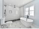 Renovated bathroom featuring a modern shower with rain head and sleek, freestanding soaking tub at 459 Orchard Dr, Stone Mountain, GA 30083