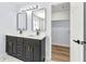 Modern bathroom with double vanity, sleek black fixtures, quartz counters, and decorative tile at 459 Orchard Dr, Stone Mountain, GA 30083