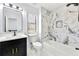 Modern bathroom featuring white tile, black accents, and a soaking tub at 459 Orchard Dr, Stone Mountain, GA 30083