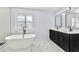Stylish bathroom features dual vanities, freestanding tub, and modern starburst tile at 459 Orchard Dr, Stone Mountain, GA 30083
