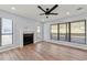 Bright living room with fireplace, wood flooring, recessed lighting, and large windows overlooking the backyard at 459 Orchard Dr, Stone Mountain, GA 30083
