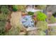 Aerial view of a private backyard featuring a stone patio, lush lawn, and mature trees at 107 Grand Ave, Suwanee, GA 30024