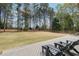 Lush backyard featuring a spacious lawn, surrounded by mature trees, with a deck that's perfect for relaxation at 107 Grand Ave, Suwanee, GA 30024