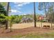 Exterior view of home with a sprawling backyard and mature trees at 107 Grand Ave, Suwanee, GA 30024