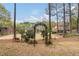 Sprawling backyard with mature trees, landscaping, and swing set at 107 Grand Ave, Suwanee, GA 30024