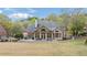 View of the house exterior, showing the spacious backyard and deck area with an outdoor seating arrangement at 107 Grand Ave, Suwanee, GA 30024