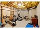 Basement space featuring exercise equipment and unfinished ceiling at 107 Grand Ave, Suwanee, GA 30024