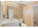 Well-lit bathroom featuring tile floors, vanity and shower at 107 Grand Ave, Suwanee, GA 30024