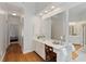 Bright bathroom with a vanity and storage; hallway leading to a bedroom can be seen in the background at 107 Grand Ave, Suwanee, GA 30024