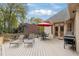 Outdoor deck area with a grill, table with umbrella, and lounge chairs, perfect for relaxing or entertaining at 107 Grand Ave, Suwanee, GA 30024