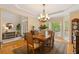 Elegant dining room with hardwood floors, chandelier, and large windows, perfect for formal gatherings and Gathering meals at 107 Grand Ave, Suwanee, GA 30024
