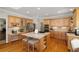 Bright kitchen features wood cabinets, granite countertops, island, and desk area at 107 Grand Ave, Suwanee, GA 30024