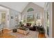 Bright living room with large windows offering view of landscaped backyard at 107 Grand Ave, Suwanee, GA 30024