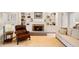 Living room with a brick fireplace, built-in shelves, and comfortable seating at 107 Grand Ave, Suwanee, GA 30024