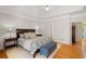 Bright and inviting main bedroom features a tray ceiling, hardwood floors, and a cozy seating area at 107 Grand Ave, Suwanee, GA 30024