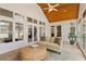 Cozy sunroom with wood ceiling, tile floors, and lots of natural light at 107 Grand Ave, Suwanee, GA 30024