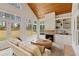 Inviting sunroom with fireplace, built-ins, and many windows at 107 Grand Ave, Suwanee, GA 30024