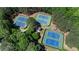 Aerial view of community tennis courts surrounded by lush landscaping at 107 Grand Ave, Suwanee, GA 30024