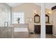 Bright bathroom featuring tiled shower, double vanity, and ample sunlight at 192 Palisade Point Dr, Ellenwood, GA 30294