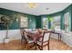 Inviting dining room with wainscoting, elegant chandelier and ample natural light from bay windows at 192 Palisade Point Dr, Ellenwood, GA 30294