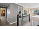 Open hallway with hardwood floors, and decorative lighting showcasing the home's architectural details at 192 Palisade Point Dr, Ellenwood, GA 30294