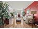 Bright living room with laminate floors, a bay window, and plants throughout at 192 Palisade Point Dr, Ellenwood, GA 30294