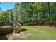 Spacious backyard with a deck, lawn, and wooded area at 210 Mels Way, Stockbridge, GA 30281