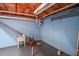 Basement area with painted walls, and open ceiling, offering room for storage and potential customization at 210 Mels Way, Stockbridge, GA 30281