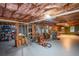Spacious basement with exposed ceiling and a mix of storage, work, and recreational spaces with lots of potential at 210 Mels Way, Stockbridge, GA 30281
