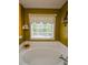 Bright bathroom featuring a deep soaking tub under a window with a decorative floral valance at 210 Mels Way, Stockbridge, GA 30281