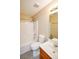 Bathroom with shower-tub combo, white toilet and vanity with sink and wood cabinet at 210 Mels Way, Stockbridge, GA 30281