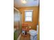 Bathroom with a frosted glass shower and a classic white toilet under a window with blinds at 210 Mels Way, Stockbridge, GA 30281