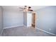 Cozy bedroom features neutral walls, carpet flooring, and a ceiling fan with light fixture at 210 Mels Way, Stockbridge, GA 30281