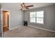 Simple bedroom with neutral carpet, a view into the hallway, and a window with blinds at 210 Mels Way, Stockbridge, GA 30281
