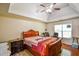A main bedroom featuring hardwood floors and a tray ceiling that enhances its size and elegance at 210 Mels Way, Stockbridge, GA 30281