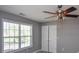 Cozy bedroom with a ceiling fan, double closets, and a window with blinds at 210 Mels Way, Stockbridge, GA 30281