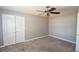 Neutral bedroom with ceiling fan, carpeted floors, and ample closet space at 210 Mels Way, Stockbridge, GA 30281