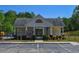 Exterior of community clubhouse building with gated pool access, accessible parking and community signage at 210 Mels Way, Stockbridge, GA 30281
