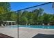 Community pool area featuring lounge chairs and a pergola, set against a backdrop of lush green trees at 210 Mels Way, Stockbridge, GA 30281