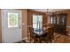 A dining room with wooden furniture, chandelier, and a decorative glass door at 210 Mels Way, Stockbridge, GA 30281