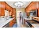 A kitchen featuring stainless steel appliances, light countertops, and wooden cabinets at 210 Mels Way, Stockbridge, GA 30281