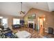 Spacious living room with a vaulted ceiling, fireplace, and hardwood floors, creating a welcoming atmosphere at 210 Mels Way, Stockbridge, GA 30281