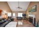 Bright living room boasts a fireplace, a ceiling fan, and hardwood flooring at 210 Mels Way, Stockbridge, GA 30281