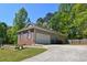 Features a brick and vinyl exterior, an attached garage, and a spacious driveway at 210 Mels Way, Stockbridge, GA 30281