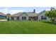 Expansive backyard with covered patio, mature landscaping, and ample space for recreation at 7425 Twin Creek Ct, Cumming, GA 30041