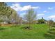 The home features a beautiful backyard, complete with verdant lawn and manicured mature trees at 7425 Twin Creek Ct, Cumming, GA 30041