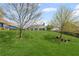 Green backyard featuring a large lawn with mature trees and landscaping at 7425 Twin Creek Ct, Cumming, GA 30041